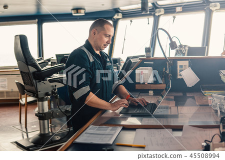 Marine navigational officer is using laptop or notebook at sea Marine navigational officer is using laptop or notebook at sea 45508994