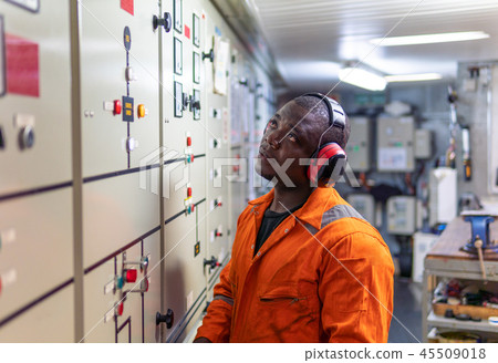Marine engineer officer working in engine room 45509018