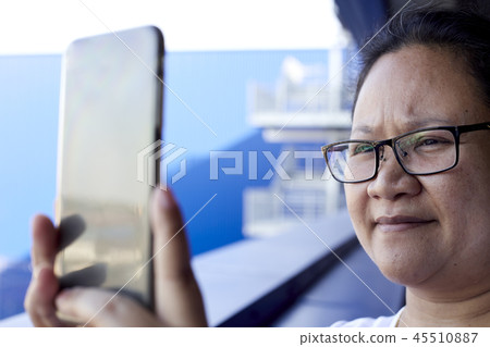 Woman using mobile phone to take photo Woman using mobile phone to take photo 45510887