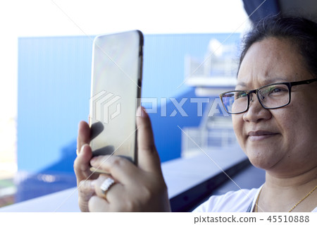 Woman using mobile phone to take photo Woman using mobile phone to take photo 45510888