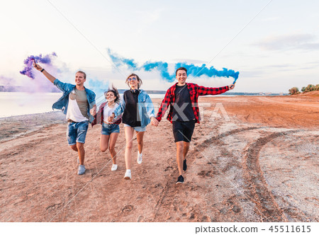 young friends running with hand flare or fusee young friends running with hand flare or fusee 45511615