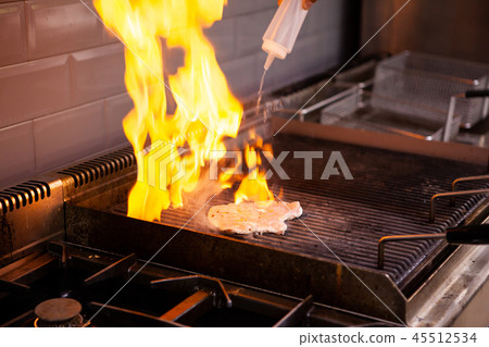 Chef making flambe chicken breast Chef making flambe chicken breast 45512534
