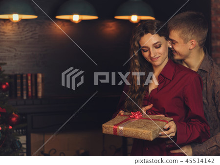 A loving couple celebrates Christmas A loving couple celebrates Christmas 45514142