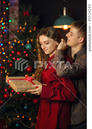 A loving couple celebrates Christmas A loving couple celebrates Christmas 45514143