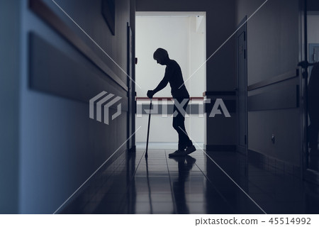 Woman is leaning on stick during visit to clinic 45514992