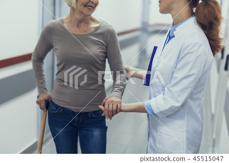 Female doctor is supporting aged lady by hand 45515047