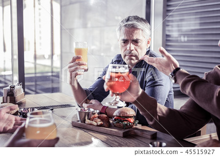 Sad mature man communicating with his friends Sad mature man communicating with his friends 45515927