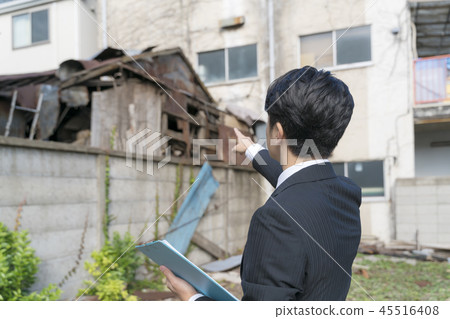 Salesman pointing at construction demolition work / property Salesman pointing at construction demolition work / property 45516408