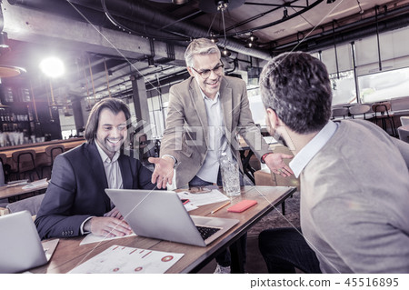 Positive delighted workers talking about modern technologies Positive delighted workers talking about modern technologies 45516895