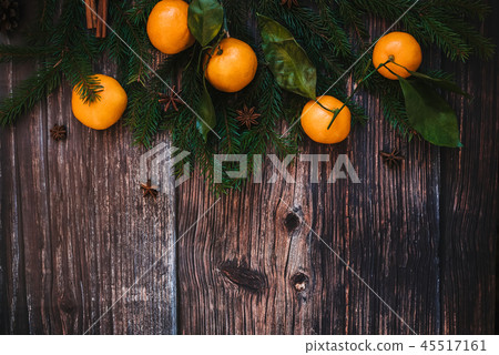 Christmas background with Mandarins, fir branches, cinnamon and star anise. Decorative festive 45517161