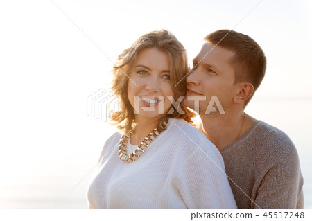 Young family romanticly hugging each other outdoor 45517248