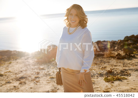 Pregnant young woman walking near the river Pregnant young woman walking near the river 45518042
