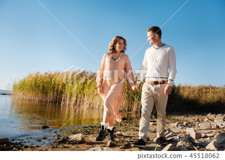 Happy couple walking together while waiting for a baby Happy couple walking together while waiting for a baby 45518062