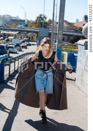 Stylish fashion blogger wearing denim shorts and baggy coat Stylish fashion blogger wearing denim shorts and baggy coat 45518255
