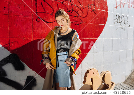 Fashionable woman wearing yellow jacket and silver accessories 45518635