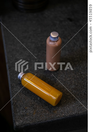 Spa cosmetics in bottles on dark gray table Spa cosmetics in bottles on dark gray table 45519859