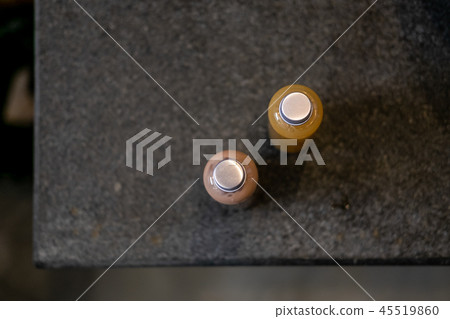 Spa cosmetics in bottles on dark gray table Spa cosmetics in bottles on dark gray table 45519860
