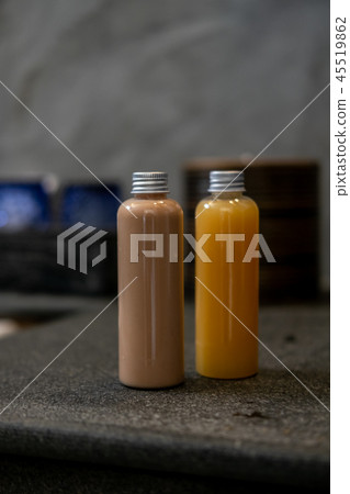 Spa cosmetics in bottles on dark gray table Spa cosmetics in bottles on dark gray table 45519862