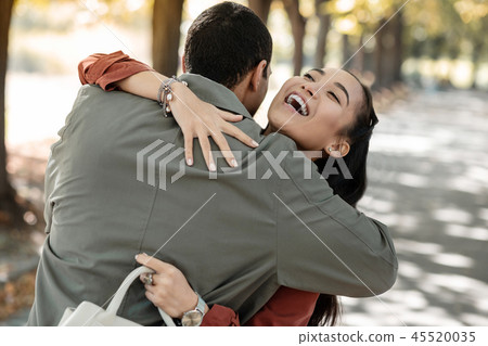 Kind international couple spending day in park Kind international couple spending day in park 45520035