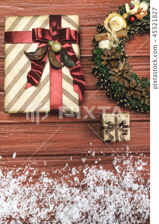 Christmas wreath and present on wooden background Christmas wreath and present on wooden background 45521827