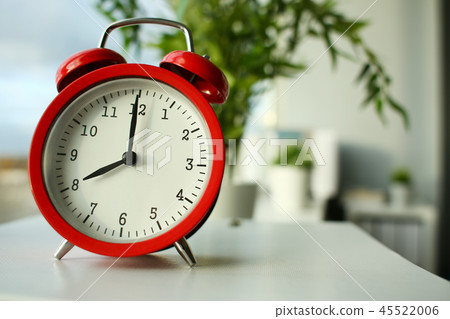 Red alarm clock set at seven in the morning 45522006