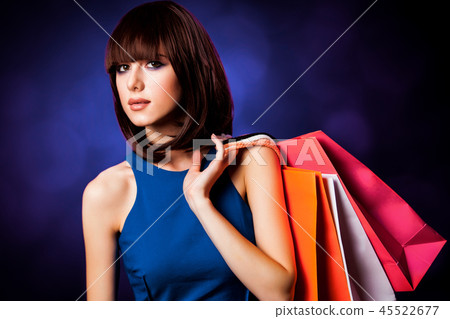 girl with shopping bags on violet background. girl with shopping bags on violet background. 45522677