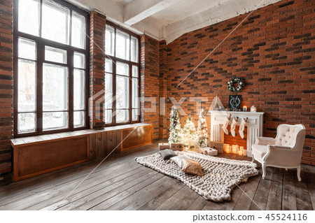 Loft apartments, brick wall with candles and Christmas tree wreath. White wool socks for Santa on Loft apartments, brick wall with candles and Christmas tree wreath. White wool socks for Santa on 45524116