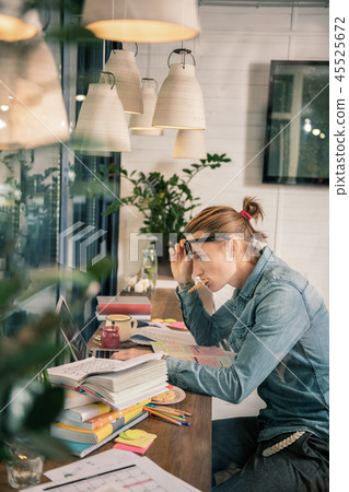 Pleasant young man being involved into studying 45525672