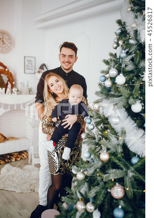 Family near Christmas tree Family near Christmas tree 45526817