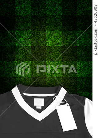 Blank label with black football shirt on grass 45526908