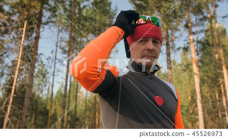 Training an athlete on the roller skaters. Biathlon ride on the roller skis with ski poles, in the Training an athlete on the roller skaters. Biathlon ride on the roller skis with ski poles, in the 45526973