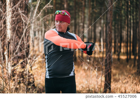 Training an athlete on the roller skaters. Biathlon ride on the roller skis with ski poles, in the 45527006