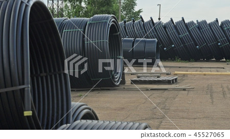 Warehouse of finished plastic pipes industrial outdoors storage site. Manufacture of plastic water Warehouse of finished plastic pipes industrial outdoors storage site. Manufacture of plastic water 45527065