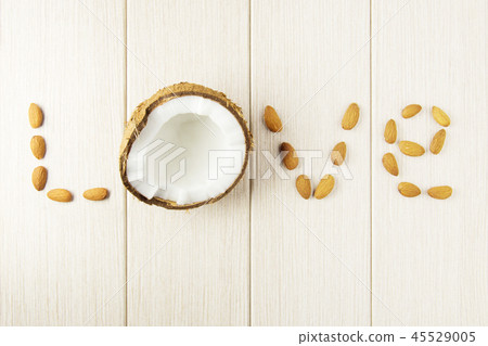 Composition with coconut and almonds on the wood. 45529005