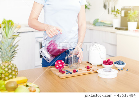 Preparing detox fruits smoothie in blender 45535494