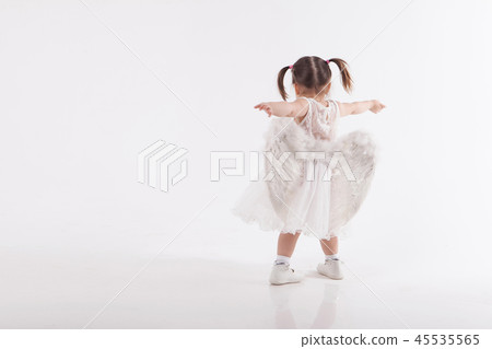 little girl in white dress with wings playing little girl in white dress with wings playing 45535565