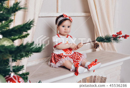 girl through the branches of a Christmas tree 45536286
