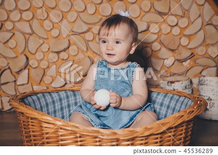 small child sitting with a Christmas ball small child sitting with a Christmas ball 45536289