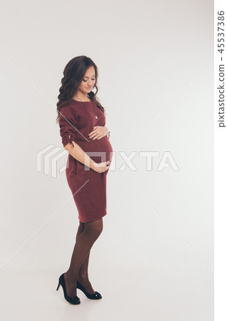pregnant woman in dress stroking her belly pregnant woman in dress stroking her belly 45537386