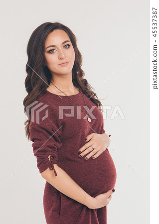 pregnant woman in dress stroking her belly pregnant woman in dress stroking her belly 45537387