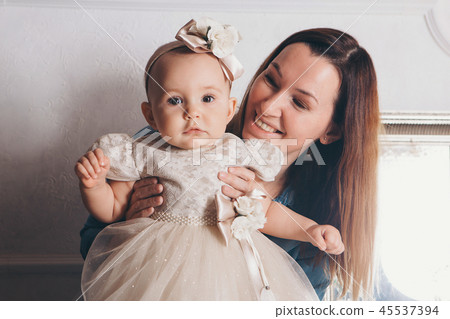 baby in arms of the mother. Woman holding a child 45537394