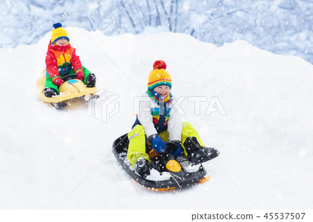 Boy on sled ride. Child sledding. Kid on sledge 45537507