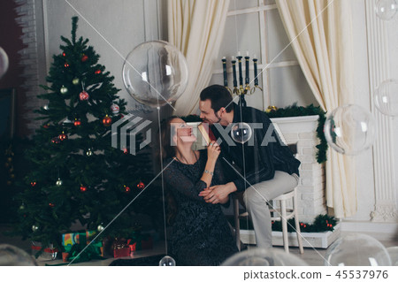 man and girl reading a book by the Christmas tree man and girl reading a book by the Christmas tree 45537976