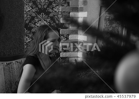 woman through the branches of a Christmas tree 45537979
