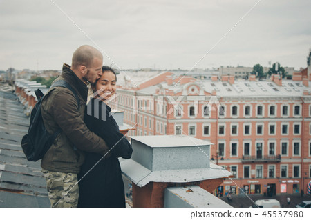 man and woman standing on the edge of the roof man and woman standing on the edge of the roof 45537980