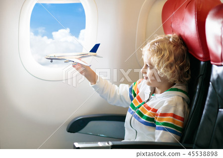 Child flying in airplane. Flight with kids. Child flying in airplane. Flight with kids. 45538898
