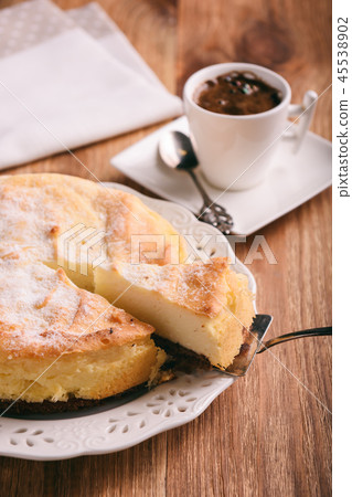 Homemade vanilla cheesecake and cup of coffee. Homemade vanilla cheesecake and cup of coffee. 45538902