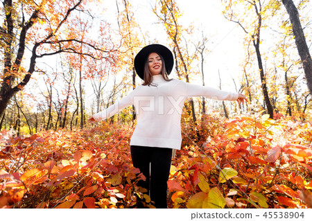 happy woman having fun in park on autumn sunny day. happy woman having fun in park on autumn sunny day. 45538904