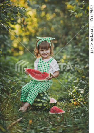 Smiling child with a piece of juicy watermelon Smiling child with a piece of juicy watermelon 45539692