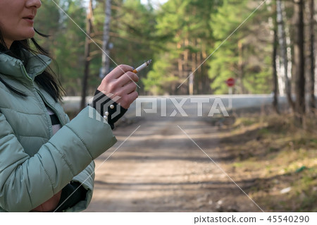 cigarette in the hand of a smoking girl cigarette in the hand of a smoking girl 45540290